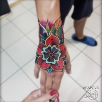Colorful flower tattoo on wrist