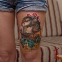 Colorful ship tattoo on leg