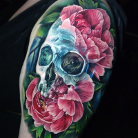 Colorful skull and peony tattoo on shoulder