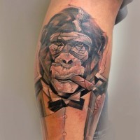 Cool black-and-white chimpanzee in tuxedo with tobacco pipe tattoo on arm