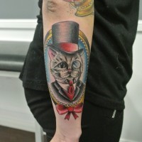 Cool cartoon old school cat in frame tattoo on outer forearm