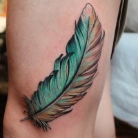 Cool colored feather tattoo on thigh