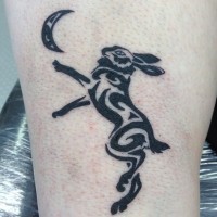 Cool tribal black hare with moon tattoo on shin