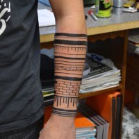 Cool tribal bricked black-ink tattoo sleeve on forearm