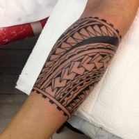 Cool trible ornamented band tattoo on forearm