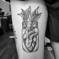 Creative heart in bottle tattoo on leg
