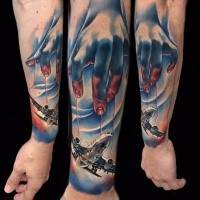 Creepy colored half sleeve tattoo of human hand and plane puppet