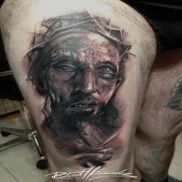 Creepy looking detailed thigh tattoo of JEsus portrait with vine
