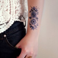 Cute blue vintage flowers tattoo on arm