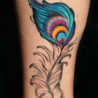 Cute colorful peacock feather tattoo on shin