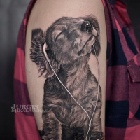 Cute dog with haedphones tattoo on shoulder