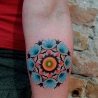 Cute painted by Mariusz Trubisz forearm tattoo of nice flower