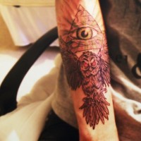 Demonic like colored evil animal owl with Masonic pyramid tattoo on arm