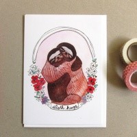 Embracing sloth couple surrounded with red flowers tattoo design