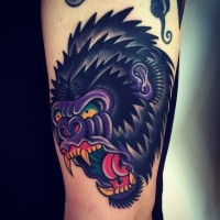 Enraged shaggy color-ink gorilla head tattoo on arm