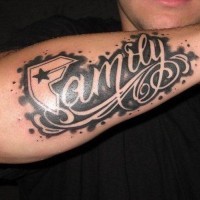 Family quote on black background tattoo on arm