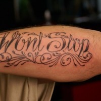 Fine curle-lettered wont stop quote tattoo on arm