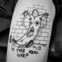 Funny and comic banana tattoo on leg