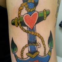 Tatuaje  de ancla abigarrada con corazón pequeño rojo