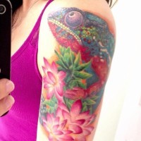 Girly vivid colored chameleon with pink flowers tattoo on arm