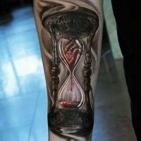 Gloomy hourglass with blood and heart forearm tattoo