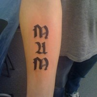 Gothic-lettered mum word tattoo on forearm