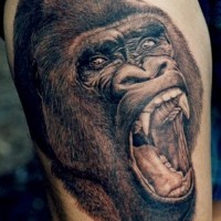 Great black-and-white gorilla head tattoo on thigh