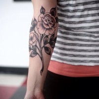 Great black-ink vintage rose flower on stem tattoo on arm