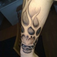 Great burning skull tattoo on outer forearm