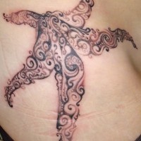 Great curled black-and-white starfish tattoo on side