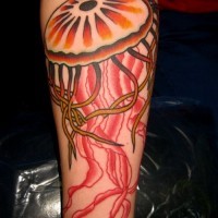 Great girly orange and red jellyfish tattoo on arm