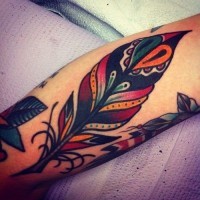 Tatuaje en el brazo, pluma decorativa de varios colores, old school