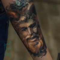 Great sttuue face tattoo on forearm