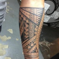 Great trible black-and-white otnamented sleeve tattoo on forearm