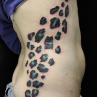 Gren and violet cheetah print tattoo on side