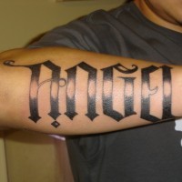 Huge-lettered angel word tattoo on forearm