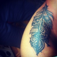 Huge black-and-white tribal feather tattoo on side