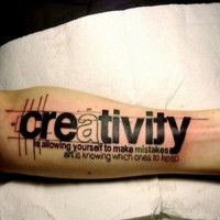 Huge printed black-lettered creativity quote tattoo on arm