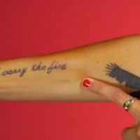 I carry the fire quote with big black bird tattoo on arm