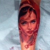 Illustrative style colord leg tattoo of cute woman portrait