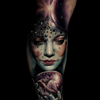 Incredible colorful woman face tattoo on lower leg