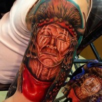 Indian head with closed eyes tattoo on shoulder