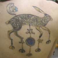 Interesting-designed hare with hanging elements tattoo on back