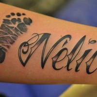 Interesting black name quote with foot print tattoo on arm