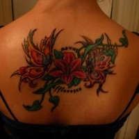 Interesting colorful exotic flower with butterfly and quote tattoo on back