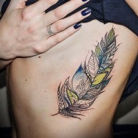 Interesting colorful tribal feather tattoo on rib-side