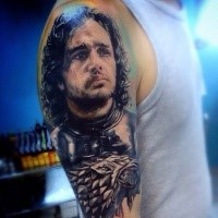 John Snow and Stark wolves tattoo on shoulder