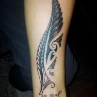 Large black tribal feather with quote tattoo on arm