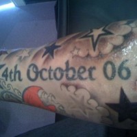 Large memorial date in clouds and stars tattoo sleeve on forearm