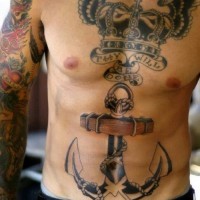 Large traditional anchor on torso with winged crown chest piece tattoo